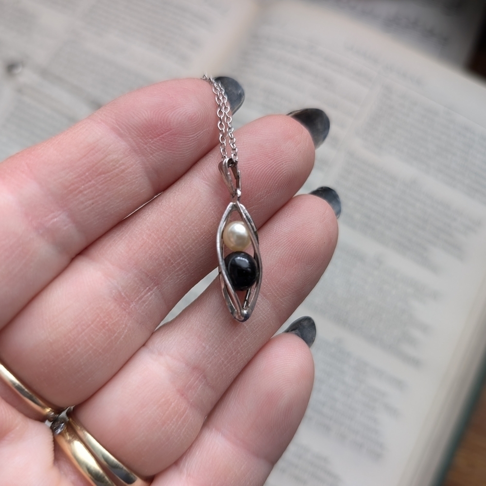Elegant Silver Pendant Necklace with Black and Cream Beads